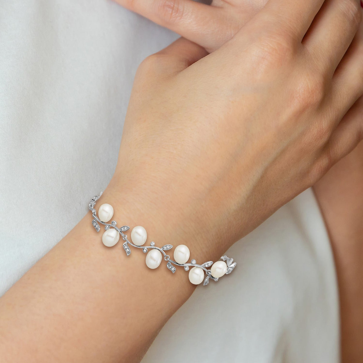 Sterling Silver Rhodium-plated 6-8mm Teardrop White Freshwater Cultured Pearl and CZ Leaf 7 inch with 1 inch Extender Bracelet