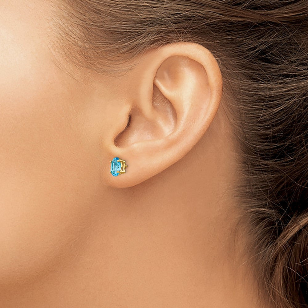 14k Yellow Gold 7x5mm Oval Blue Topaz Stud Earrings